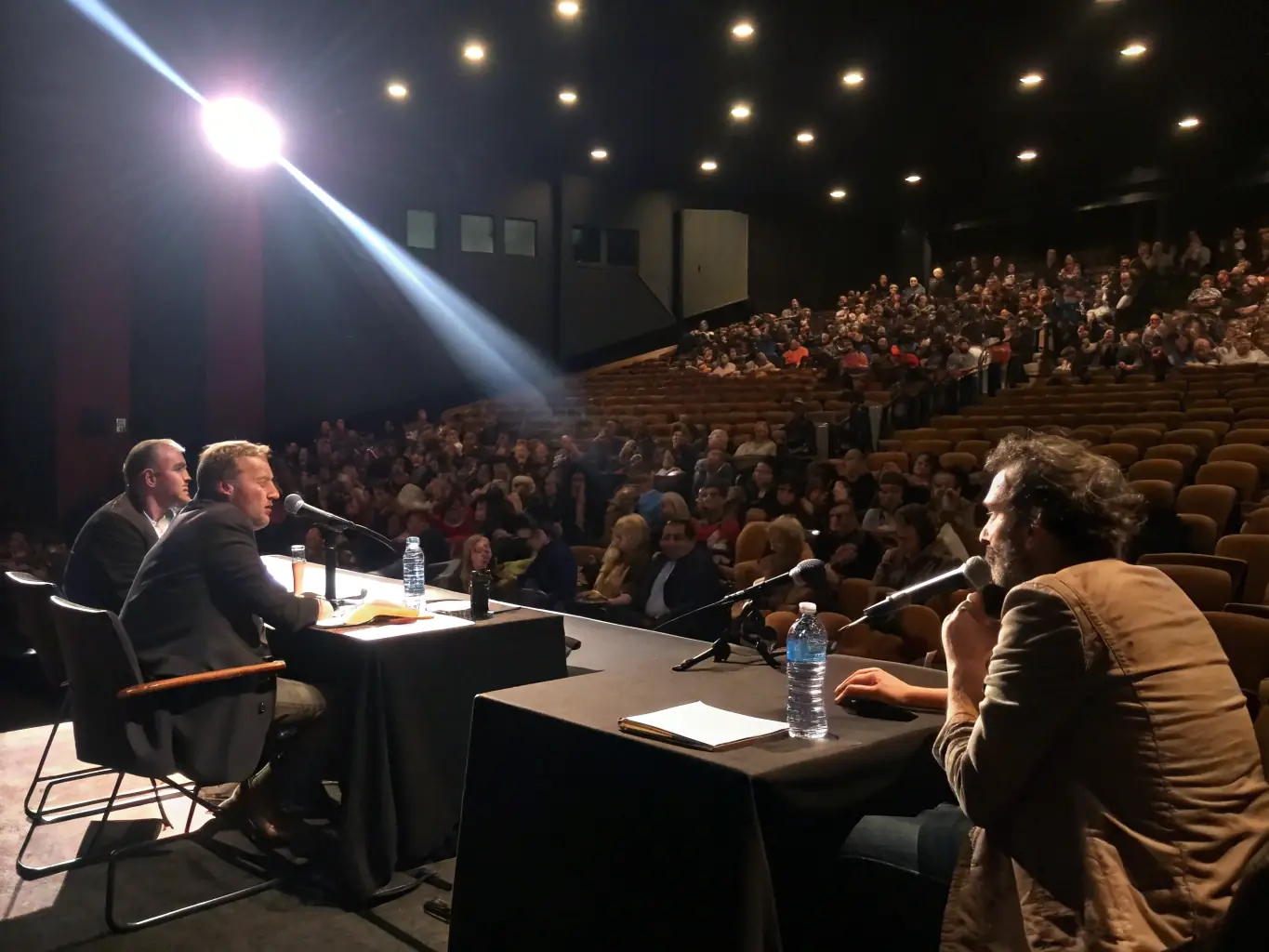 A dynamic photograph capturing the energy of the Annual Food & Beverage Industry Conference, with attendees actively participating in a panel discussion.